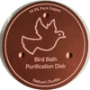 A round copper disc used for bird bath purification, labeled 99.9% Pure Copper.
