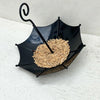 Black umbrella-shaped hanging bird feeder filled with dried seeds