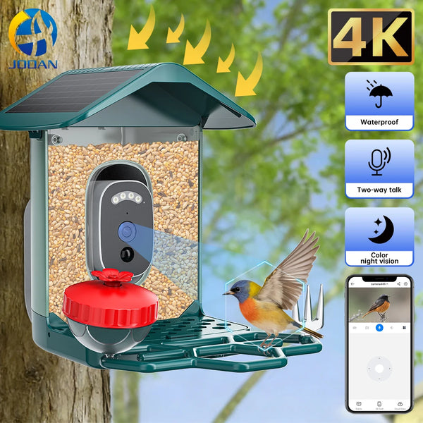 A solar-powered bird feeder camera is mounted on a tree, featuring a camera and a feeding tray for monitoring birds.