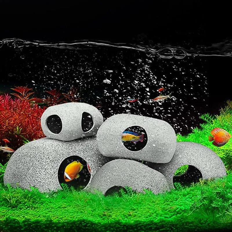 A ceramic cichlid cave aquarium decor featuring natural filtration and various fish swimming in water.