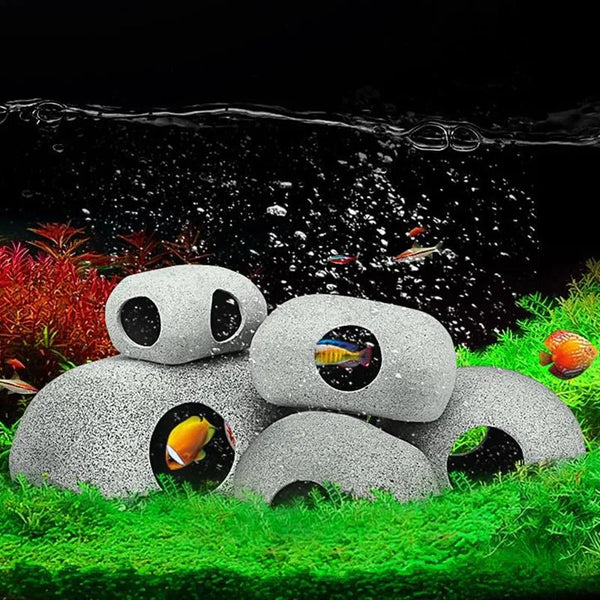 A ceramic cichlid cave aquarium decor featuring natural filtration and various fish swimming in water.