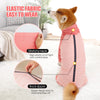 A dog wearing a pink elastic fabric jumpsuit with a stretchy neck and back zipper.