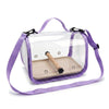 A purple portable bird travel carrier with a clear viewing panel and a wooden perch.