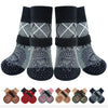 A pack of four anti-slip dog traction socks in black and gray patterns.