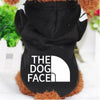A black fleece dog hoodie with a white logo featuring the text THE DOG FACE