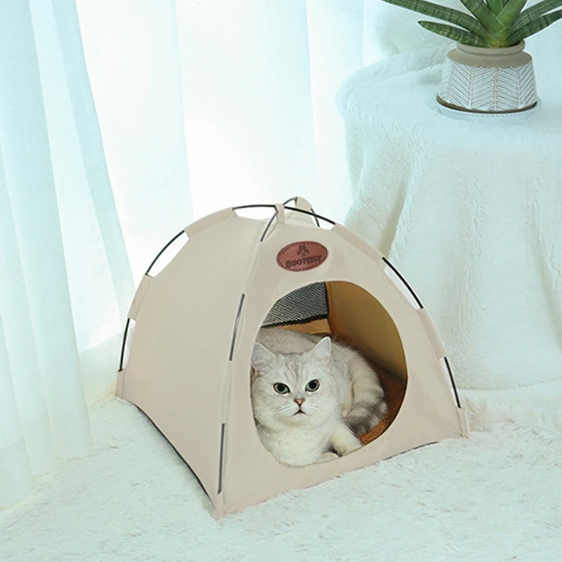 A beige foldable pet tent for cats is shown with an entrance, resting on a white fluffy surface.