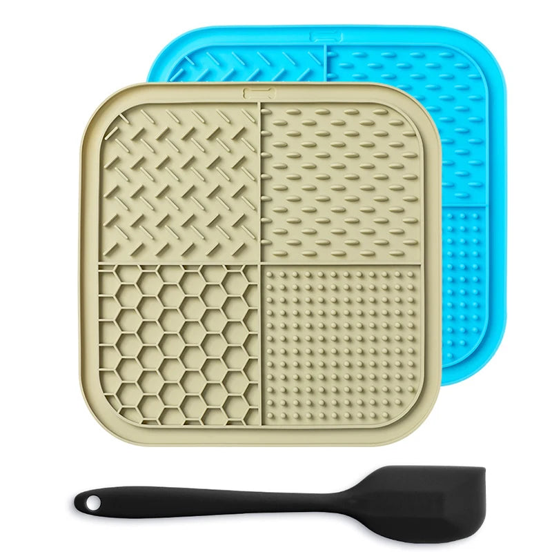 A beige silicone lick mat for pets is shown next to a black silicone spoon.