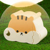A light beige cartoon hamster hideout house with a viewing window resting on green grass.