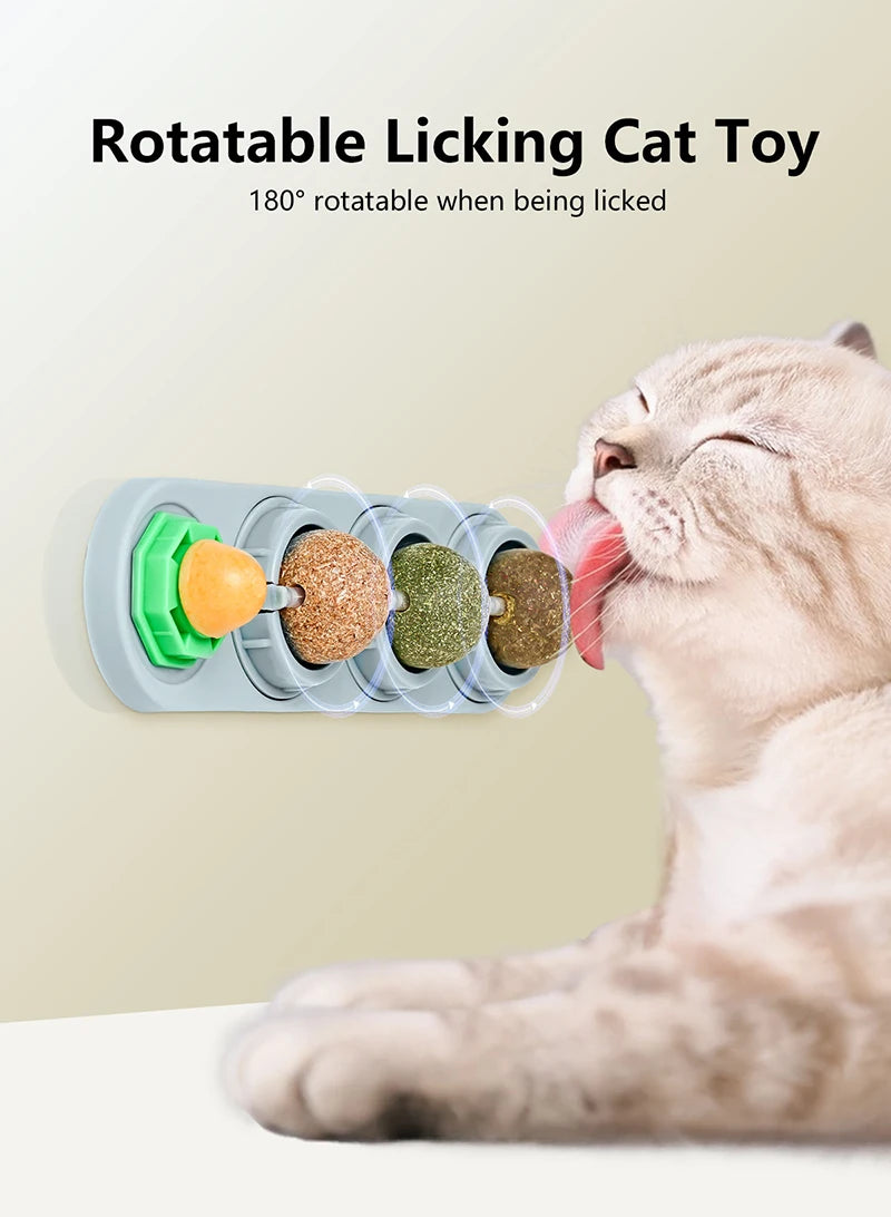 A cat is licking a rotating toy made of edible catnip balls for dental health and play.