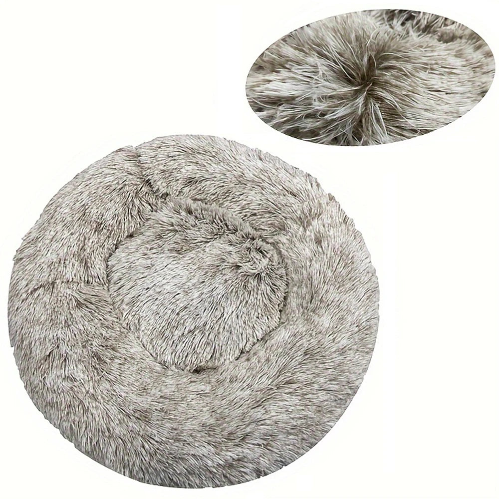 A round, plush pet bed with a removable washable cover in a gray, textured fabric.