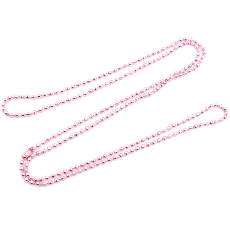 A set of pink plated ball bead necklaces laid out on a white background.