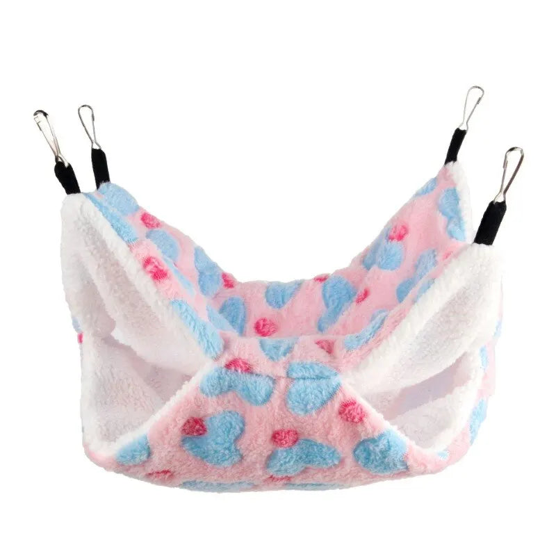A pink and blue fluffy pet hammock with hanging loops for small animals