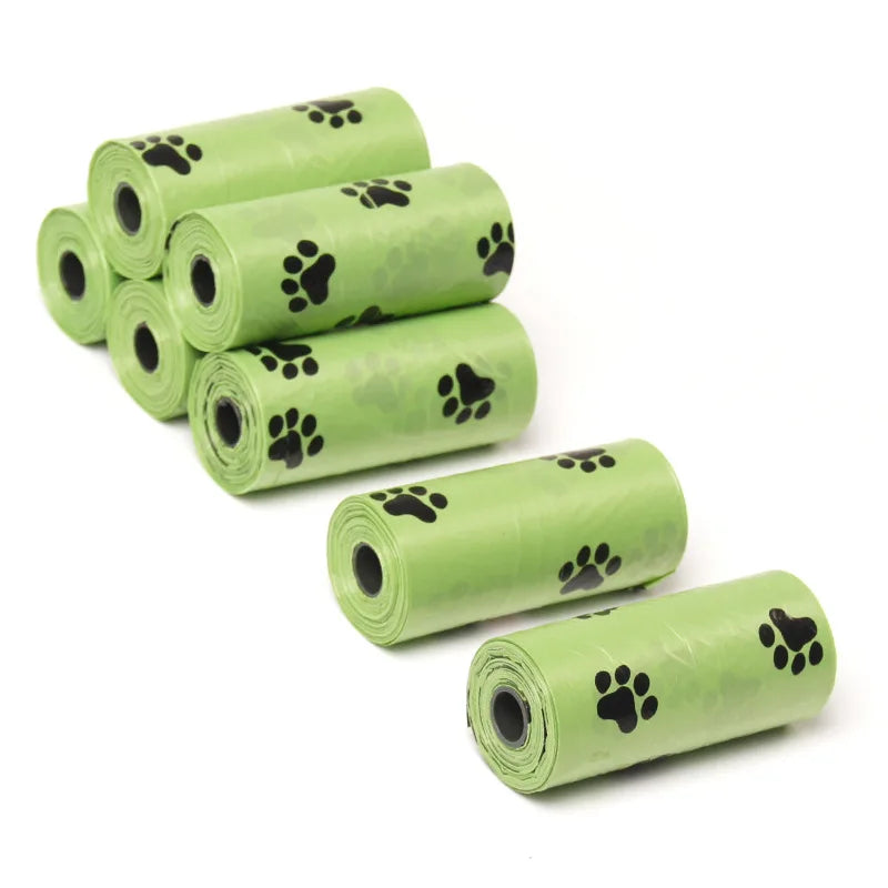 A stack of twenty rolls of biodegradable dog waste bags with paw prints on a green background.
