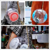A clear glass ball filled with water and a pink exercise ball is being held by a person.