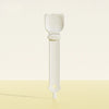 A white long-handled pet food dispensing spoon with a wide scoop and a small tip.