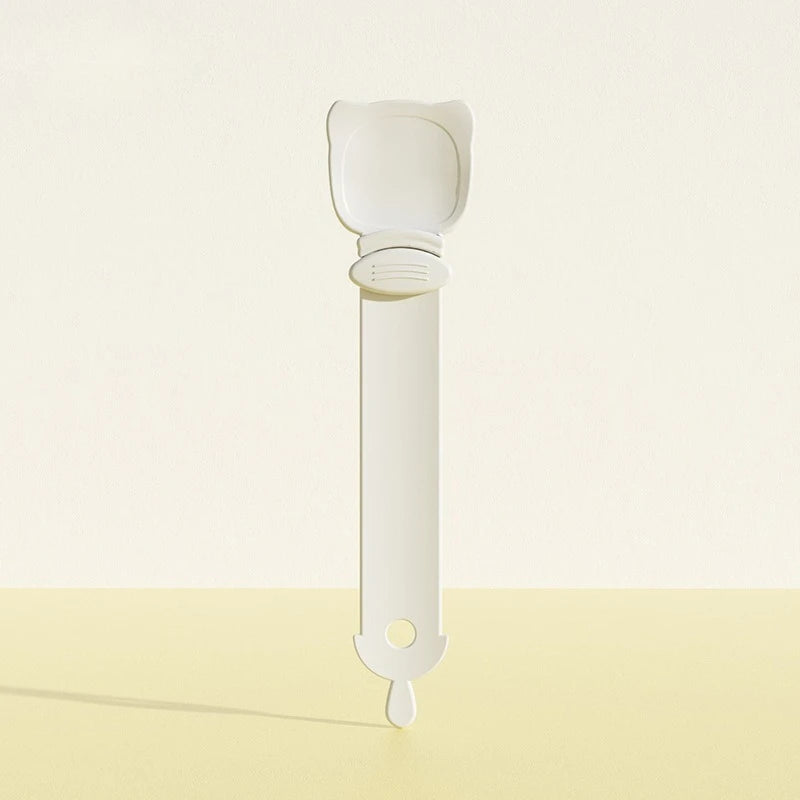 A white long-handled pet food dispensing spoon with a wide scoop and a small tip.