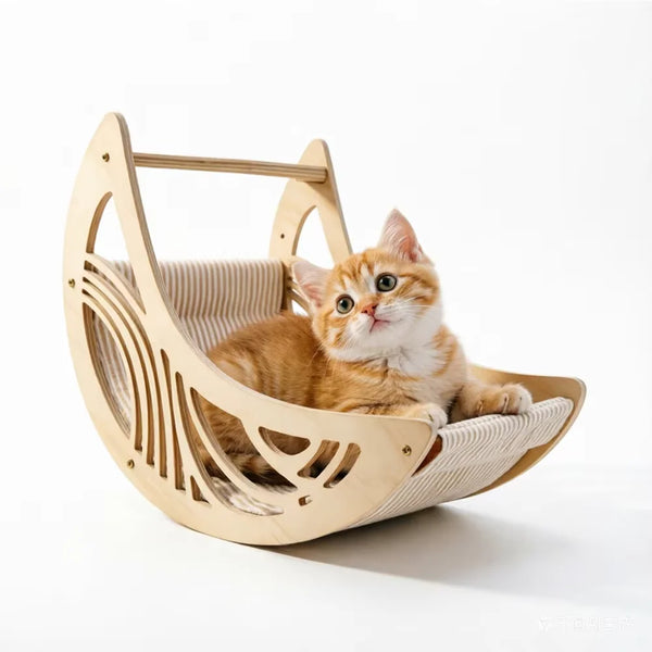 A fluffy orange tabby kitten is resting inside a wooden cat hammock with climbing steps and a moon bed.