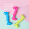 Three rubber chew toys shaped like the number 1, in blue, pink, and yellow, displayed on a light background.