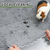 A gray fleece pet warming mat with a small orange and white guinea pig resting on it.