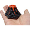 A dark volcanic rock sculpture with an orange lava flow effect, held in a person's hand.