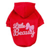 A bright red hoodie featuring a white embroidered text that reads Little Beauty