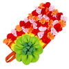 A colorful, textured mat with red, orange, and pink fabric flowers for an interactive pet foraging toy.