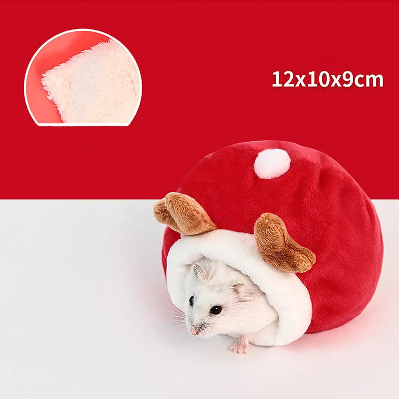 A plush red sleeping nest shaped like a hamster, featuring white fur and ears, next to a measuring scale.
