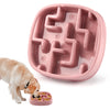A pink anti-gulping slow feeder bowl for dogs and cats is shown with a dog eating dry food.