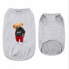 A light gray printed pet vest for a dog, featuring a black mask and red pants.