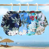 A display of colorful Hawaiian style pet dog summer beach shirts hanging on a wooden bar against a blue sky and ocean backgro