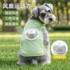 A gray dog wearing a light green cooling vest with a built-in fan, shown outdoors on grass.