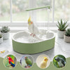 A green automatic bird shower bath for parrots with various colorful birds visible in the surrounding context.