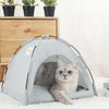A light blue cozy pet tent bed for cats resting on a white carpet.