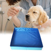 A person is using a showerhead to bathe a golden retriever in a blue foldable pet wading pool.
