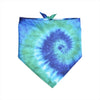 A square piece of tie-dye fabric featuring swirling shades of blue and green with a small green leaf attached.