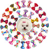 A collection of colorful pet hair bows in various patterns and colors attached with gentle rubber bands.