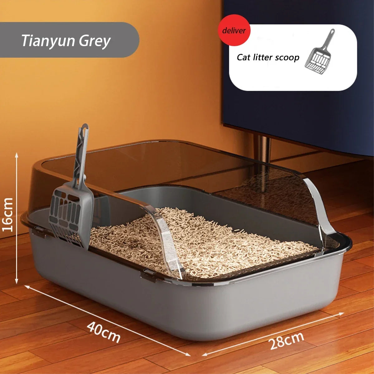 A grey semi-enclosed cat litter box with a splash guard and scoop is shown on a wooden floor.
