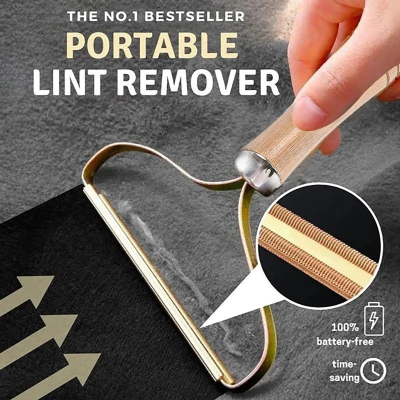 A hand holds a portable lint remover tool, showing its design and tip against a dark fabric background.