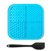 A bright blue silicone lick mat for pets with suction cups and a black silicone spoon.