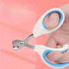 A hand holds a stainless steel nail clipper with white and blue handles against a pink background.