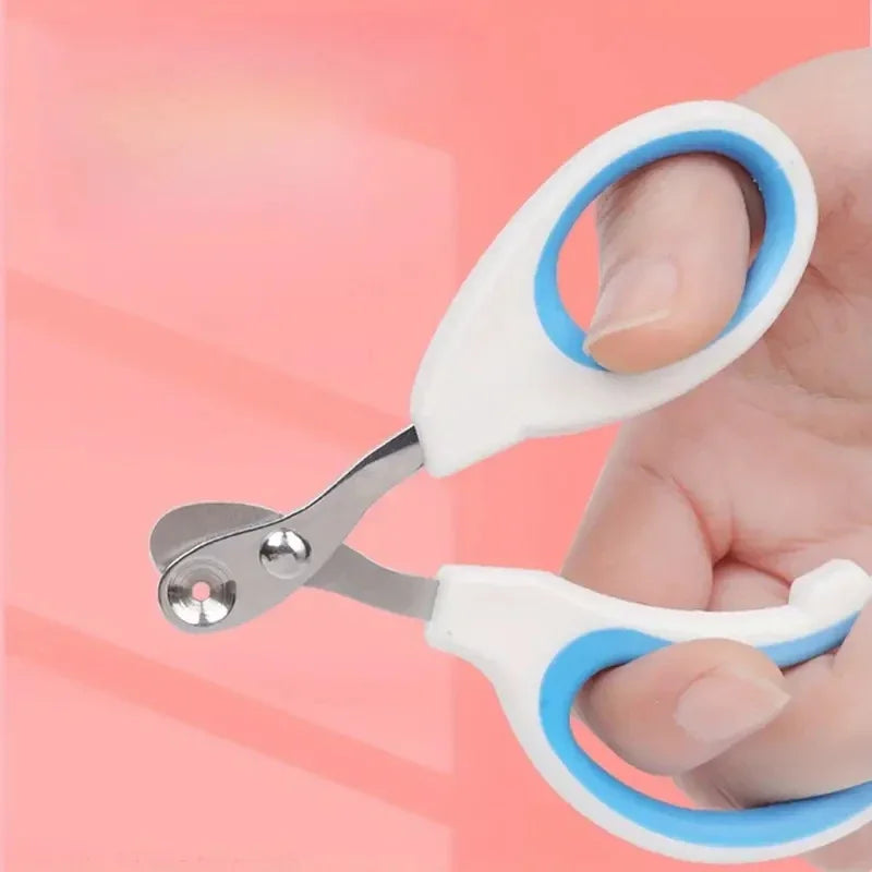 A hand holds a stainless steel nail clipper with white and blue handles against a pink background.