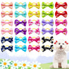 A collection of colorful pet hair bows in various patterns and colors with rubber bands displayed against a soft background.
