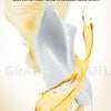 A close-up of grape seed oil dripping onto a white fabric, highlighting its moisturizing properties for hair and skin.