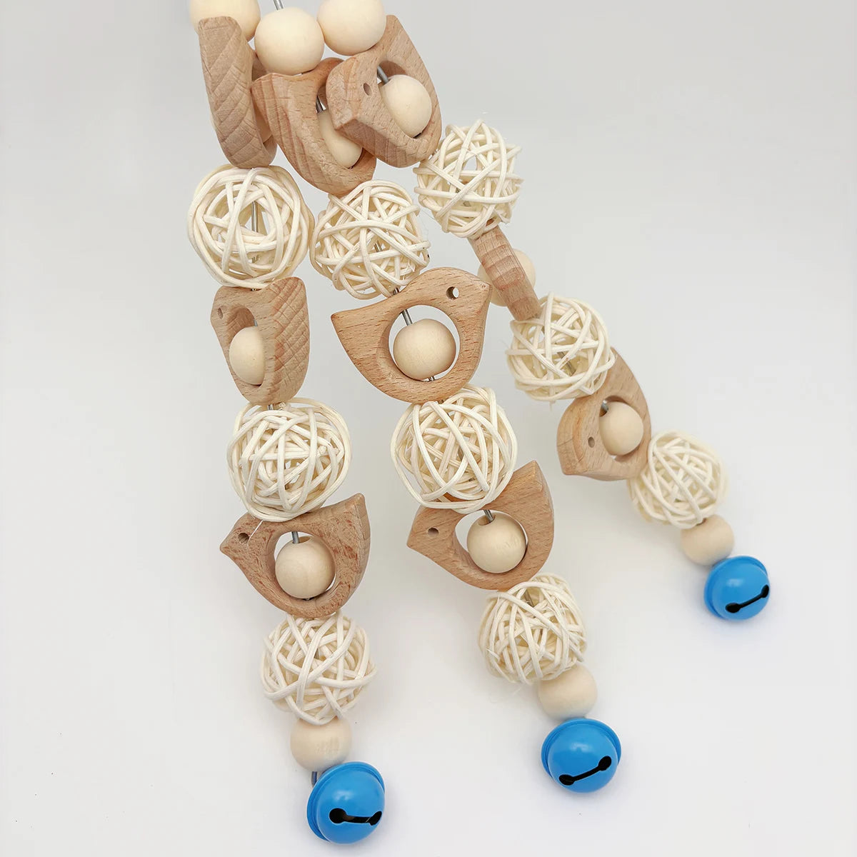 A string of wooden and natural fiber decorative parrot swing toys for birds.