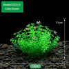 A vibrant green artificial plant model growing in a dark gravel substrate.