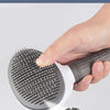 A hand holds a gray pet hair removal brush with adjustable needle body and bending features.