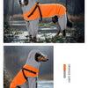 An orange and grey reflective waterproof dog raincoat with a hood is shown standing in the rain.