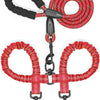 A red and black durable leather double dog leash with a shock absorbing bungee.