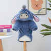 A soft blue flannel hoodie for a small dog is displayed on a wooden stand.