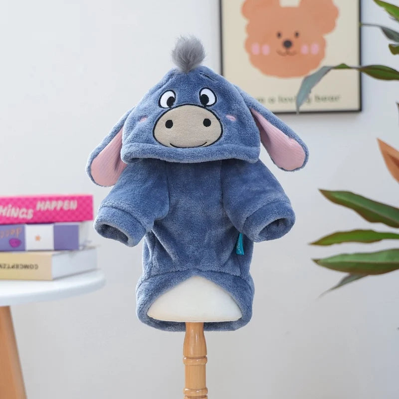 A soft blue flannel hoodie for a small dog is displayed on a wooden stand.